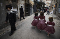 Ultra-Orthodox Jewish girls wear costumes to celebrate the Jewish holiday of Purim in Jerusalem, Sunday, Feb. 28, 2021. The Jewish holiday of Purim commemorates the Jews' salvation from genocide in ancient Persia, as recounted in the biblical Book of Esther. (AP Photo/Oded Balilty)