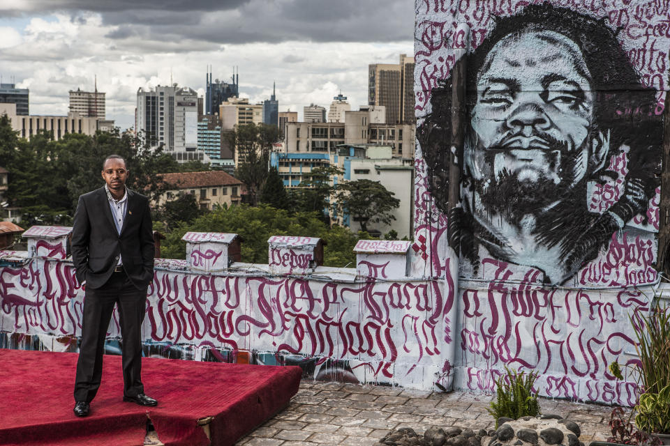Kenyan Political activist Boniface Mwangi stands for a portrait on the roof of Pawa254, an organization he founded, in Nairobi, Kenya. He stands opposite a graffiti portrait of Dedan Kimathi, a leader of the Mau Mau rebellion against British colonial rule in Kenya. Kimathi was jailed and eventually executed by the colonial administration. Mwangi claims that Kimathi is one of his idols. Boniface started as a photographer but has now morphed into a controversial political activist who uses various forms of art in his protests.