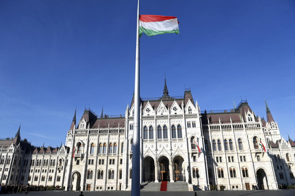 The Hungarian flag flies during a state commemoration at the parliament building in Budapest, Hungary, Sunday, Oct. 23, 2022 to mark the 66th anniversary of the outbreak of the Hungarian revolution and war of independence against communist rule and the Soviet Union in 1956. (Noemi Bruzak/MTI via AP)