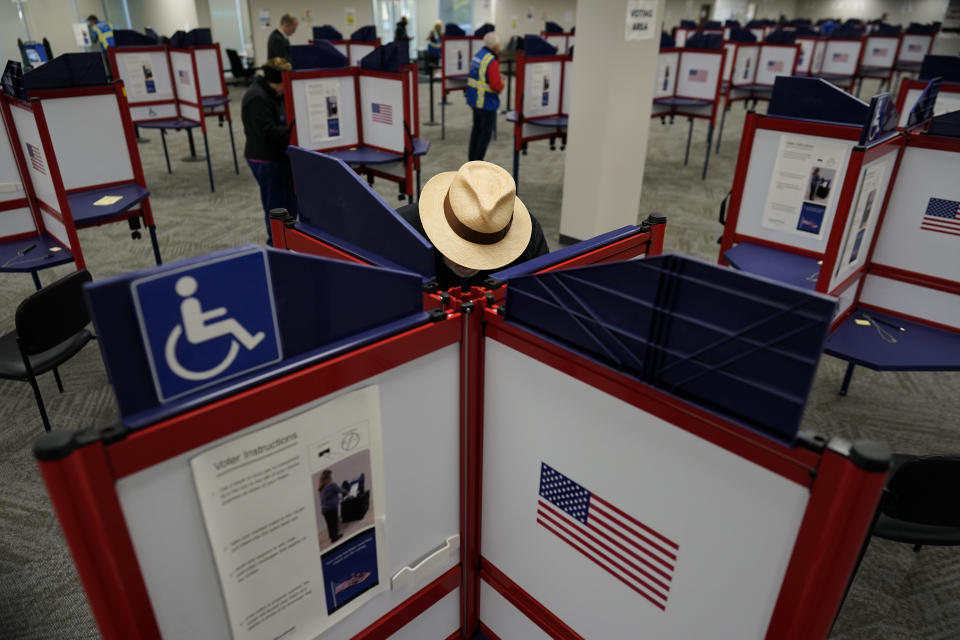 FILE - Rod Sommer stands in a partitioned booth and fills out his ballot during early in-person voting at the Hamilton County Board of Elections in Cincinnati, Wednesday, Oct. 11, 2023. (AP Photo/Carolyn Kaster, File)