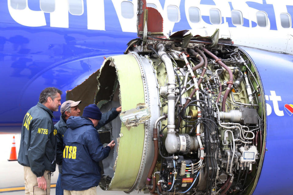 <em>National Transportation Safety Board investigators examine damage to the engine of the Southwest Airlines plane (AP)</em>