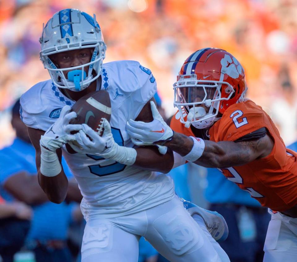 North Carolina’s Devontez Walker (9) pulls in a 43-yard pass completion from quarterback Drake Maye ahead of Clemson’s Nate Wiggins (2) in the first quarter on Saturday, November 18, 2023 at Memorial Stadium in Clemson, S.C. Robert Willett/rwillett@newsobserver.com