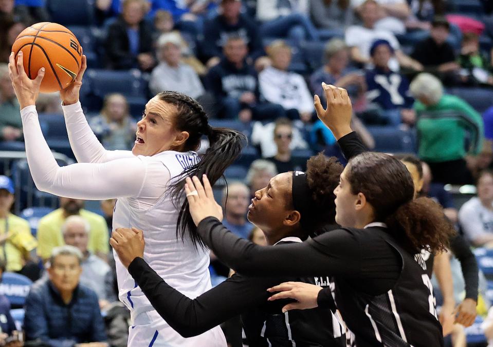 BYU Cougars forward Lauren Gustin (12) reaches for a pass in front of Rice Owls forwards India Bellamy (12) and Ashlee Austin (22) during a Women’s National Invitation Tournament basketball game at the Marriott Center in Provo on Friday, March 17, 2023. BYU lost 71-67.