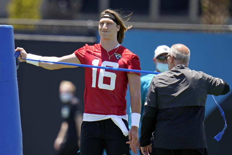 Jacksonville Jaguars quarterback Trevor Lawrence (16) stretches out during an NFL football rookie minicamp, Saturday, May 15, 2021, in Jacksonville, Fla. (AP Photo/John Raoux)
