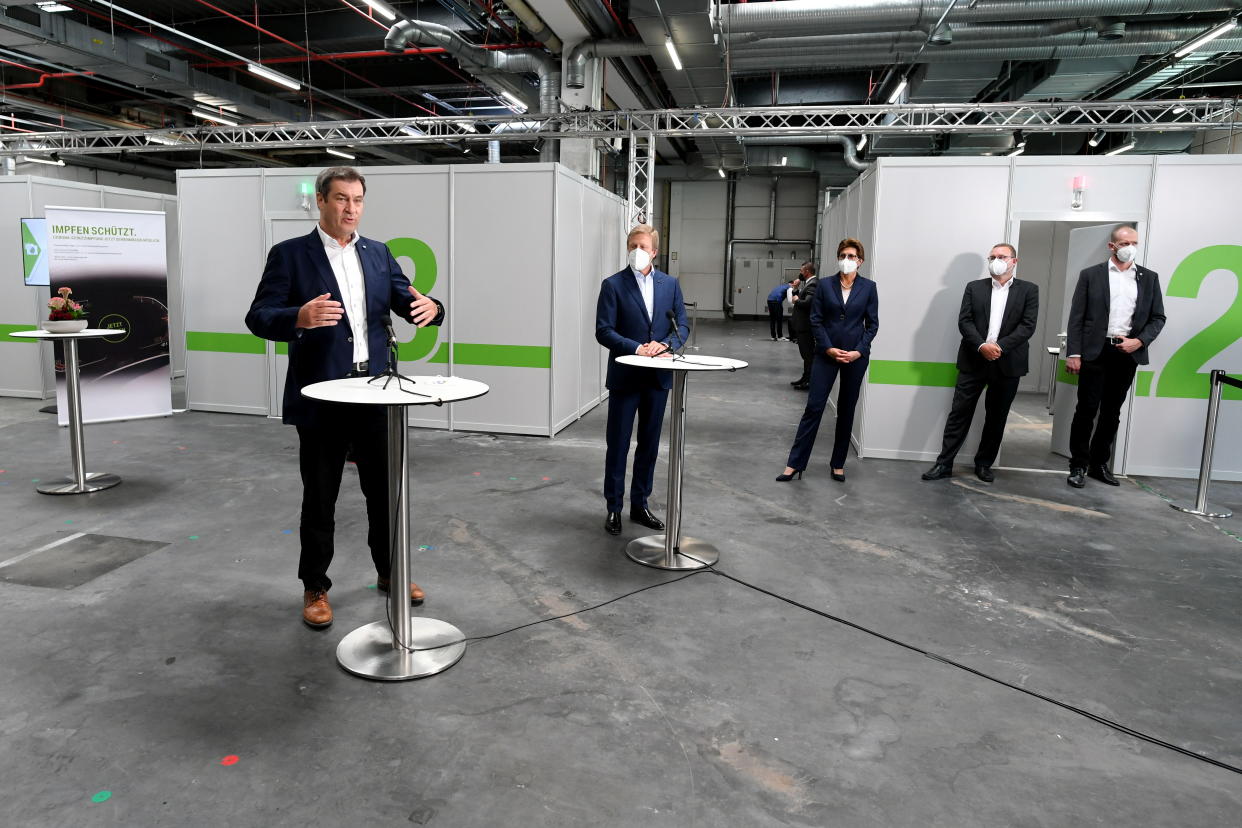 Bavarian State Premier Markus Soeder gestures next to BMW CEO Oliver Zipse as BMW starts to provide coronavirus disease (COVID-19) vaccinations for staff, in Munich, Germany, June 7, 2021. REUTERS/Andreas Gebert