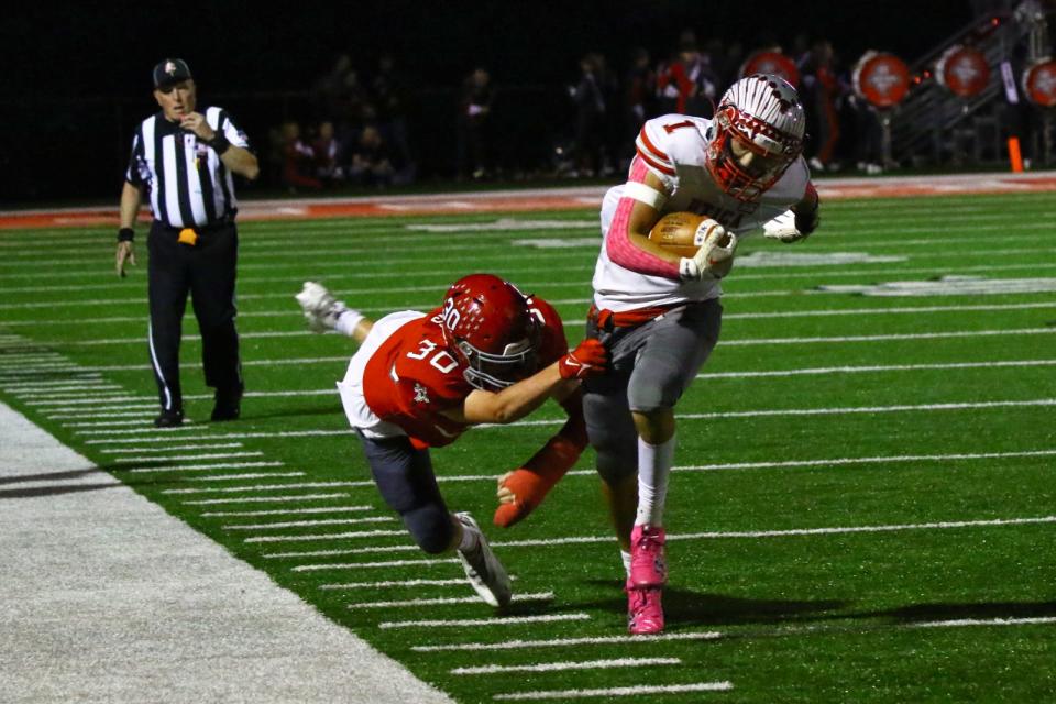 Utica's Justin Giffin breaks the tackle of Johnstown's Jacob Myers on Friday.