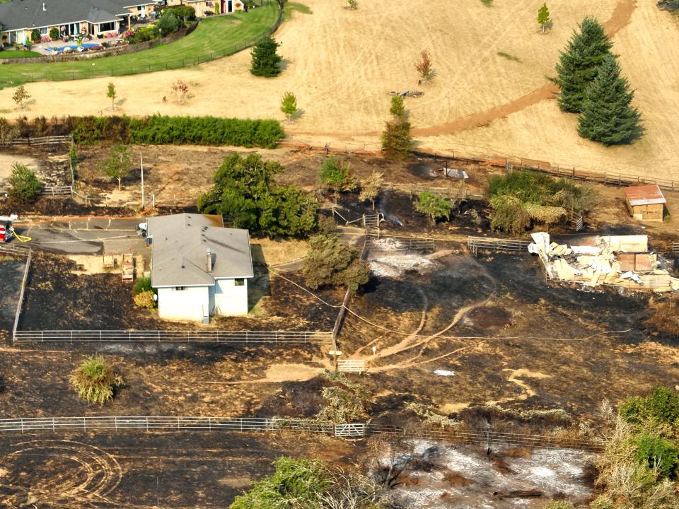 Two outbuildings to the right are destroyed during the 50-acre Liberty Fire on Aug. 23. The home to the left still stands, as seen in an aerial image captured by a Salem Police Department drone pilot.