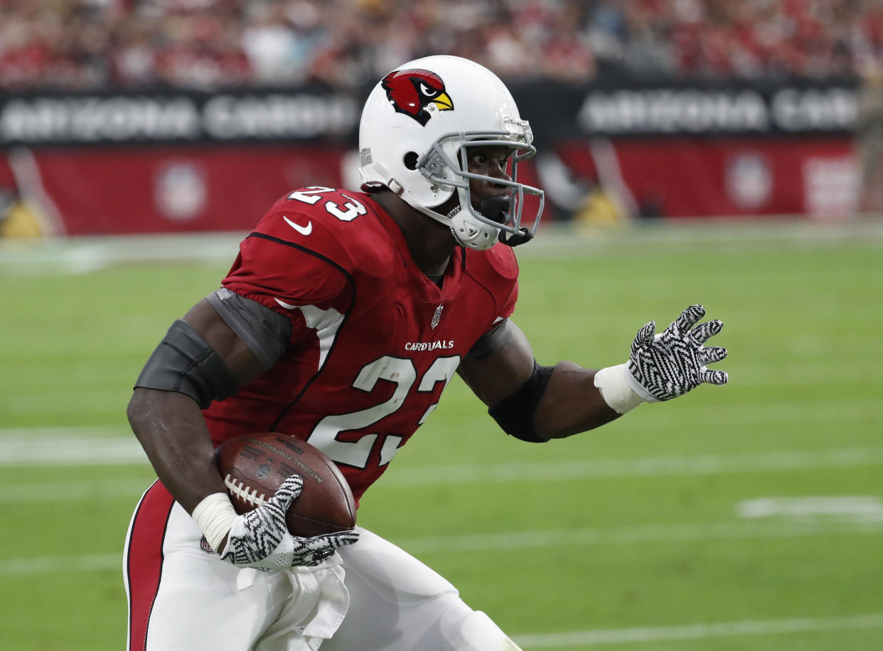 New season, new team: running back Adrian Peterson, shown here carrying the ball for the Cardinals, has reportedly signed with Washington. (AP)