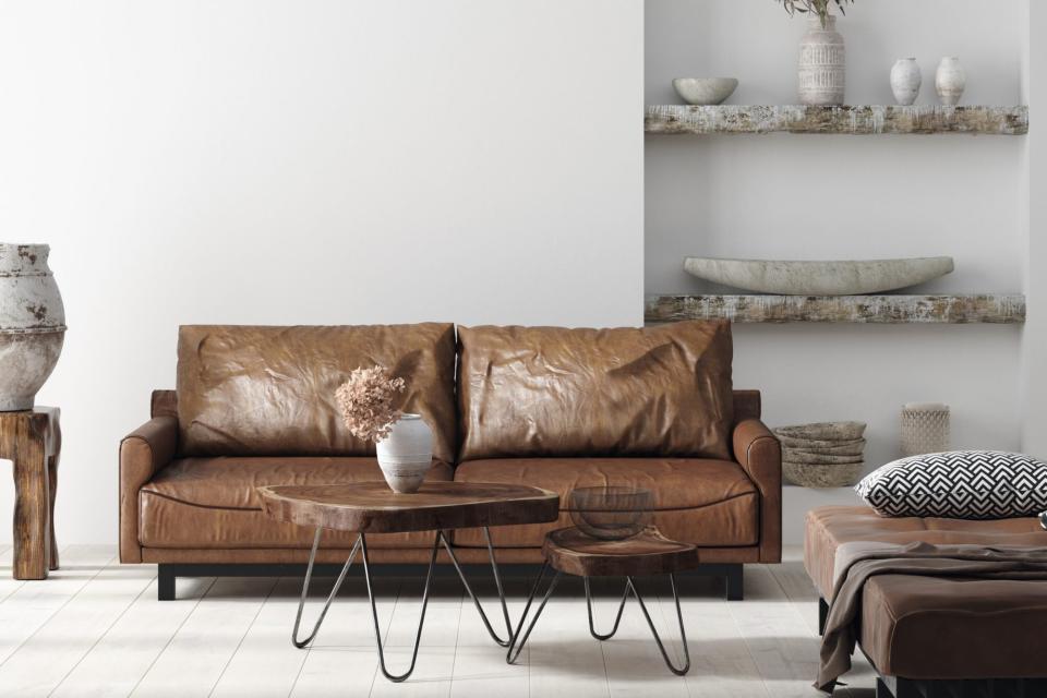 Wall mock up in Scandi-boho home interior with retro brown leather furniture