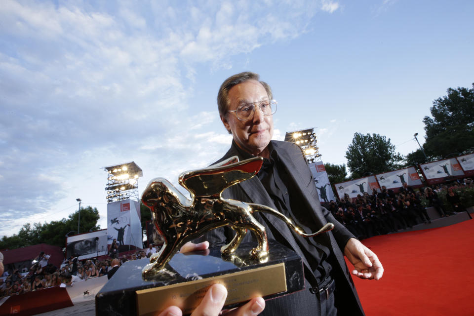 File - Director William Friedkin holds his Golden Lion for Lifetime Achievement award at the Venice Film Festival. The 77th Venice Film Festival will kick off on Wednesday, Sept. 2, 2020, but this year's edition will be unlike any others. Coronavirus restrictions will mean fewer Hollywood stars, no crowds interacting with actors and other virus safeguards will be deployed. (AP Photo/Andrew Medichini, File)