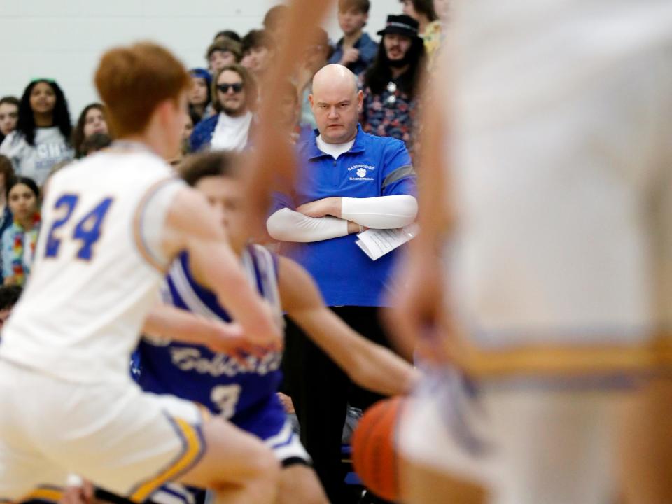 Cambridge coach Kyle Pertuset surveys the action during his team's 57-37 loss to host West Muskingum on Tuesday night in Falls Township.