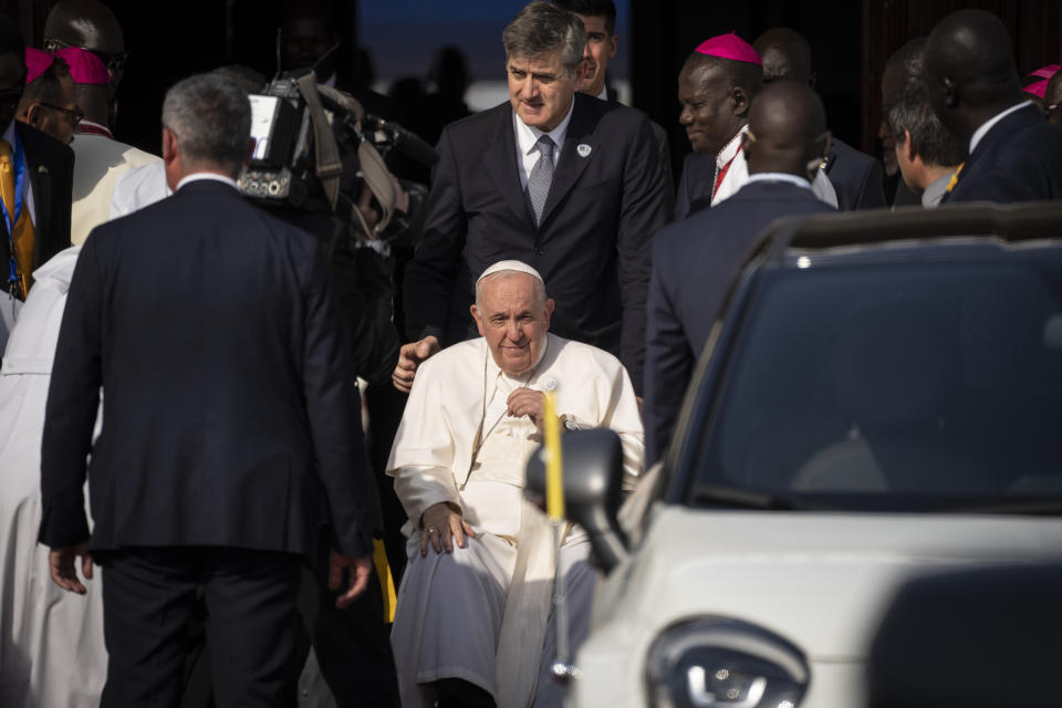 Pope Francis goes to his vehicle at the airport in Juba, South Sudan Friday, Feb. 3, 2023. Pope Francis arrived in South Sudan on the second leg of a six-day trip that started in Congo, hoping to bring comfort and encouragement to two countries that have been riven by poverty, conflicts and what he calls a "colonialist mentality" that has exploited Africa for centuries. (AP Photo/Ben Curtis)