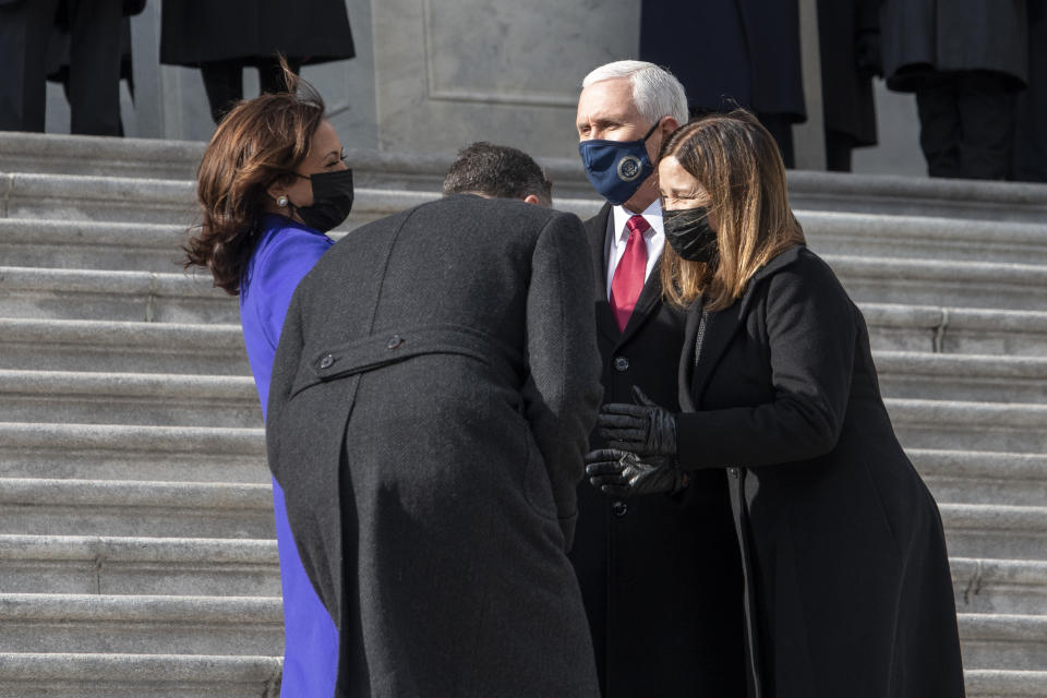 Vice President Kamala Harris and her husband Doug Emhoff, chat with former Vice President Mike Pence and his wife Karen as they walk down the Capitol steps following the inauguration of President Joe Biden, Wednesday, Jan. 20, 2021, at the U.S. Capitol in Washington. (Rod Lamkey/Pool Photo via AP)