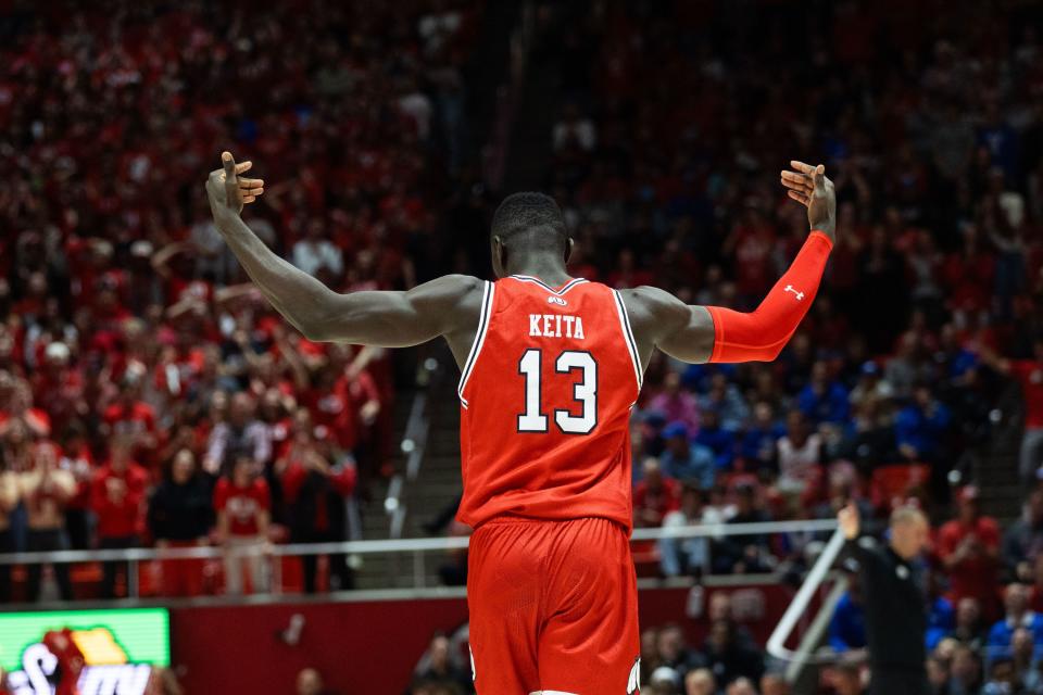 Utah Utes center Keba Keita (13) hypes the crowd after his second dunk during a mens basketball game against the Brigham Young Cougars at the Jon M. Huntsman Center in Salt Lake City on Saturday, Dec. 9, 2023.