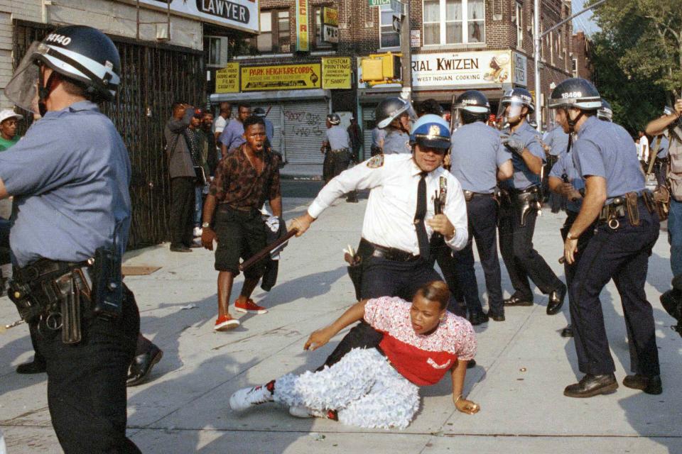 New York City police officers scuffle with a protester during a march through the Crown Heights section of Brooklyn, Aug. 21, 1991. Confrontations between police and protesters marked the third day of violence sparked by a car accident Monday night that left a 7-year-old black child dead and a Hasidic man stabbed to death in the melee that followed. (AP Photo/Joe Major)