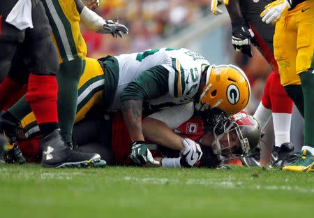 Dec 21, 2014; Tampa, FL, USA; Green Bay Packers outside linebacker Julius Peppers (56) sacks Tampa Bay Buccaneers quarterback Josh McCown (12) during the first half at Raymond James Stadium. Mandatory Credit: Kim Klement-USA TODAY Sports