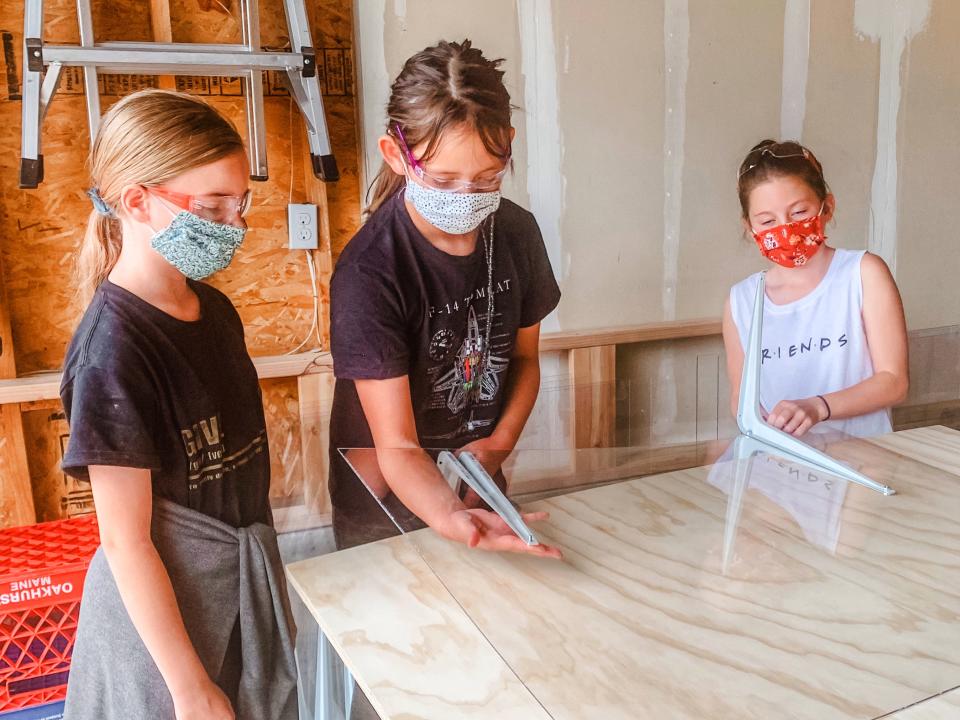 Members of Girl Scout Troop 65430 make PPE. (Photo: Randi Bangertner)