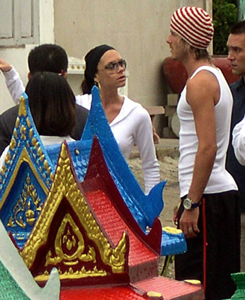 David Beckham and his wife Victoria choose for Buddhist shrines during their visit to Thai beach resort south of Bangkok, 23 June 2003. (AFP via Getty Images)