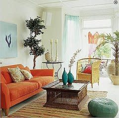 A warm orange sofa is contrasted by cool blue accents.

Source