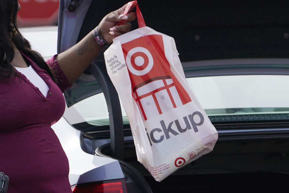 A Target employee places a curbside pickup purchase into the trunk of a customer in Jackson, Miss., Thursday, Nov. 5, 2020. After a weak start to the holiday season for many mall-based retailers, the strugglers are making their final push in the final days before and the week after Christmas. Many are stepping up discounts while heavily promoting curbside pickup as a way to get shoppers, worried about being infected with the virus, to visit their stores. But experts believe that any burst of sales will be too little and too late to save some stores. (AP Photo/Rogelio V. Solis)