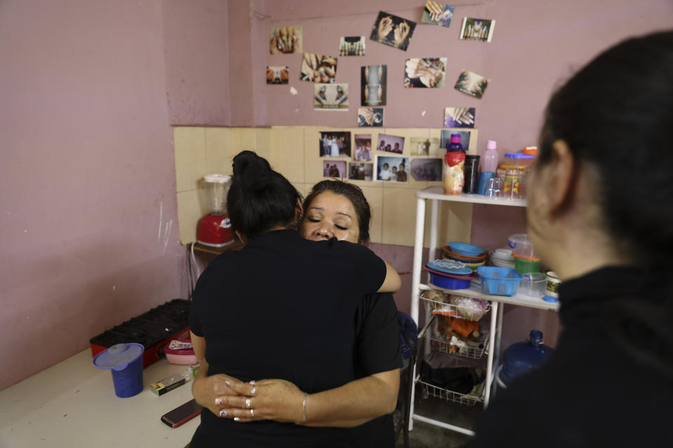 Rosa Alba Santoyo is embraced by a woman giving her condolences the day after she lost three of her adult children in an attack on the drug rehabilitation center where they were being treated, at her home in Irapuato, Mexico, Thursday, July 2, 2020. Gunmen burst into the drug rehabilitation center and opened fire Wednesday, killing 24 people and wounding seven, authorities said. (AP Photo/Eduardo Verdugo)