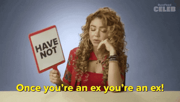 Woman holding a "HAVE NOT" sign, expressing opinions during a game or interview