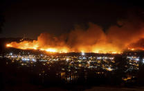 FILE - In this Oct. 31, 2019, file photo, smoke from the Maria Fire billows above Santa Paula, Calif.California regulators are voting Wednesday, Nov. 13, on whether to open an investigation into pre-emptive power outages that blacked out large parts of the state for much of October as strong winds sparked fears of wildfires. The state’s largest utility, Pacific Gas & Electric Co., initiated multiple rounds of shut-offs that plunged nearly 2.5 million people into darkness throughout northern and central California. (AP Photo/Noah Berger, File)