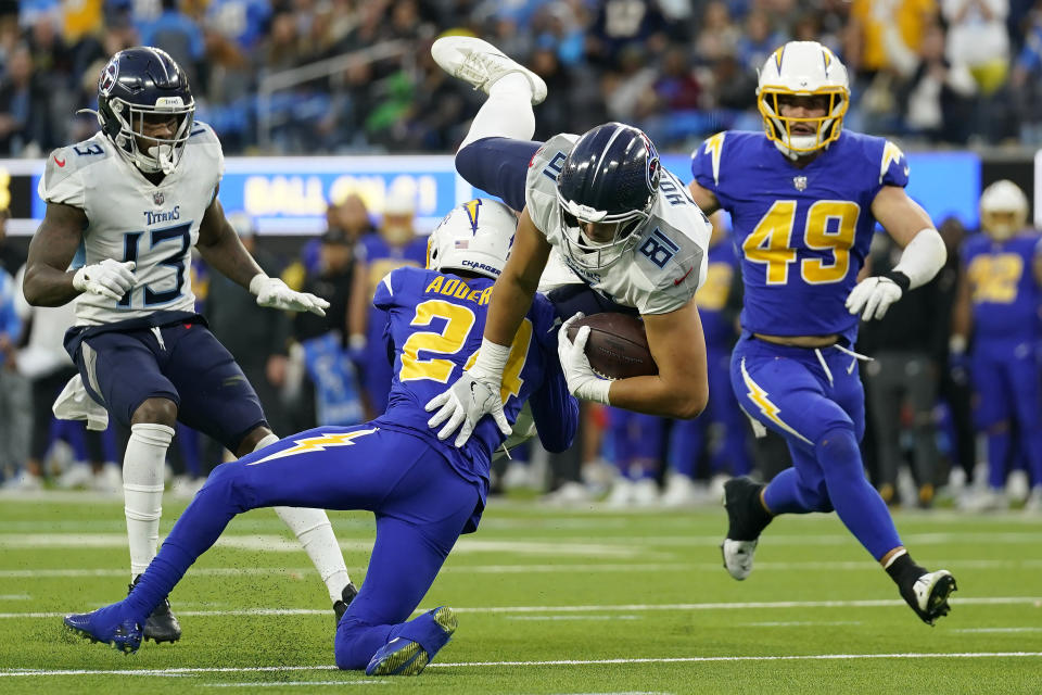 Tennessee Titans tight end Austin Hooper (81) is tackled by Los Angeles Chargers safety Nasir Adderley during the second half of an NFL football game in Inglewood, Calif., Sunday, Dec. 18, 2022. (AP Photo/Ashley Landis)