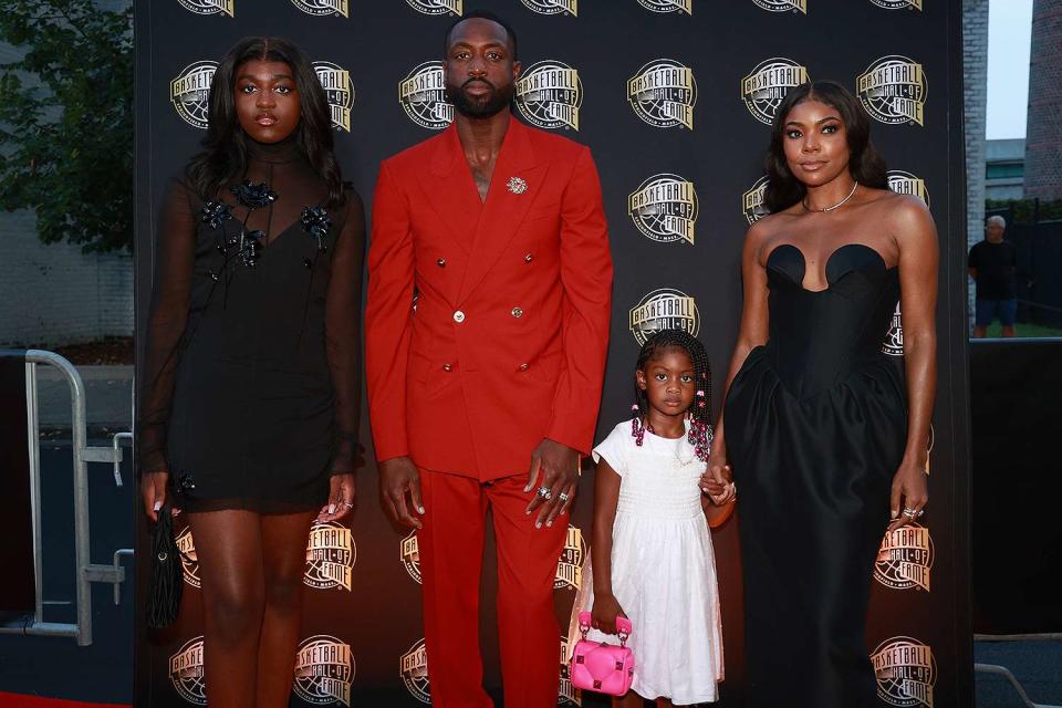 <p>Mike Lawrie/Getty </p> Dwyane Wade, Gabrielle Union and their daughters attend Basketball Hall of Fame induction ceremony