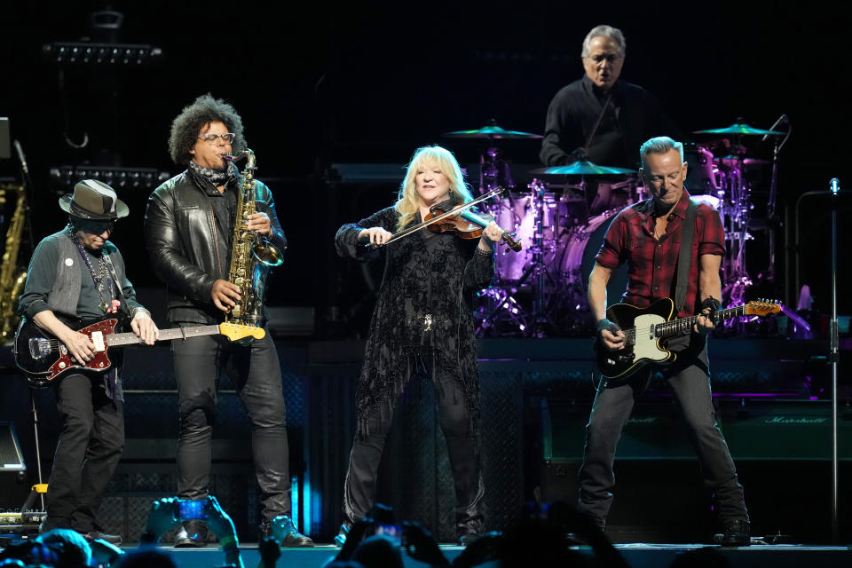 Bruce Springsteen, right, is joined by guitarist Nils Lofgren, left, Jake Clemons second from left, on saxophone, Soozie Tyrell, center, on violin, and Max Weinberg, second from right, on drums as they perform during Springsteen's concert of Bruce Springsteen and The E Street Band World Tour 2024 performance Tuesday, March 19, 2024, in Phoenix. (AP Photo/Ross D. Franklin)
