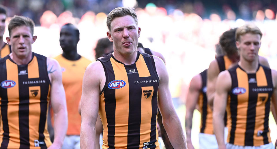 Pictured centre, James Sicily walks off after Hawthorn's loss to Essendon in the AFL. 