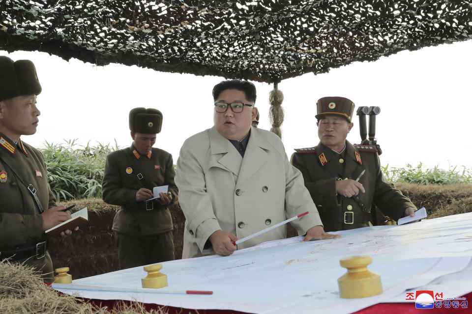 In this undated photo provided on Monday, Nov. 25, 2019, by the North Korean government, North Korean leader Kim Jong Un, center, inspects a military unit on Changrin Islet in North Korea. Independent journalists were not given access to cover the event depicted in this image distributed by the North Korean government. The content of this image is as provided and cannot be independently verified. Korean language watermark on image as provided by source reads: "KCNA" which is the abbreviation for Korean Central News Agency. (Korean Central News Agency/Korea News Service via AP)