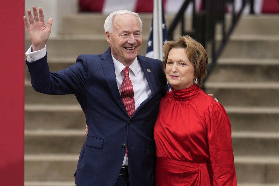 Former Arkansas Gov. Asa Hutchinson, left, embraces his wife, Susan Hutchinson, right, after she introduced him to formally announce his Republican campaign for president, Wednesday, April 26, 2023, in Bentonville, Ark.. (AP Photo/Sue Ogrocki)