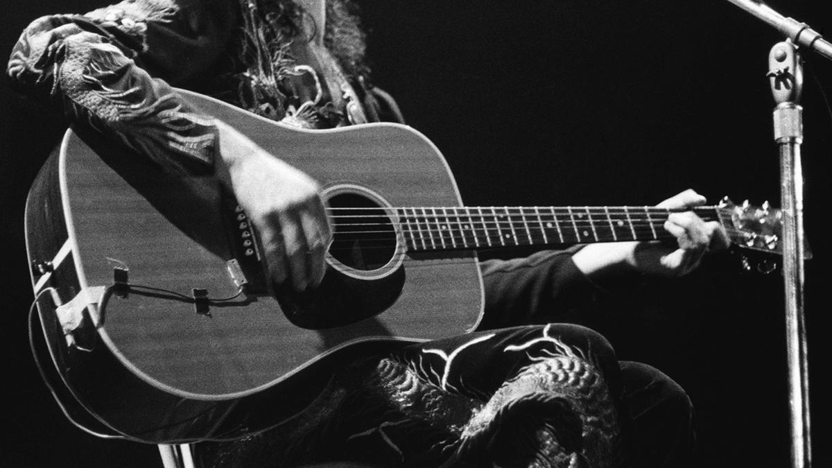  Jimmy Page playing acoustic guitar live 