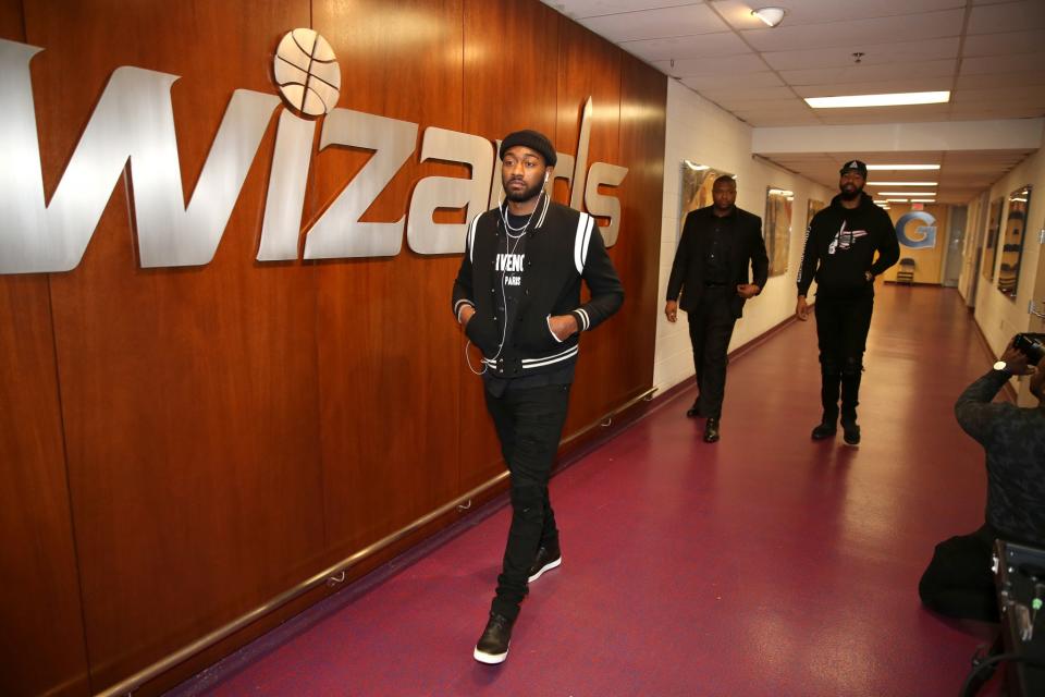 John Wall enters Verizon Center on some all black everything. (Getty Images)