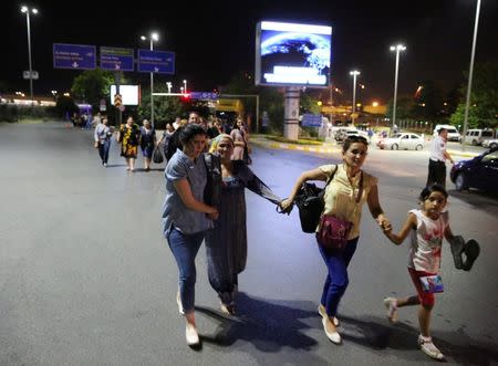 People walk away from Istanbul Ataturk airport, Turkey, following a blast June 28, 2016. REUTERS/Goran Tomasevic