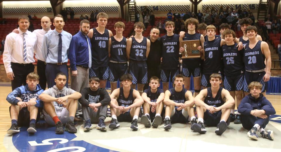 Louisville poses for a team photo after being defeated by Akron St. Vincent-St. Mary in the DII regional final at the Canton Memorial Civic Center on Saturday, March 12, 2022.