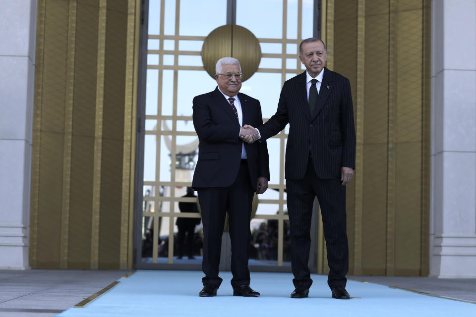 Turkey's President Recep Tayyip Erdogan, right, and Palestinian President Mahmoud Abbas shake hands during a welcome ceremony in Ankara, Turkey, Tuesday, Aug. 23, 2022. Abbas is in Turkey for a two-day state visit.(AP Photo/Burhan Ozbilici)