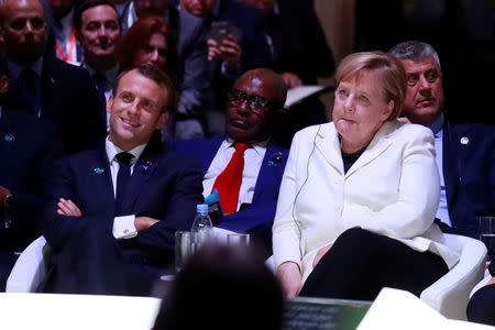 French President Emmanuel Macron and German Chancellor Angela Merkel attend the opening session of the Paris Peace Forum as part of the commemoration ceremony for Armistice Day, 100 years after the end of the First World War, in Paris, France, November 11, 2018. REUTERS/Gonzalo Fuentes/Pool