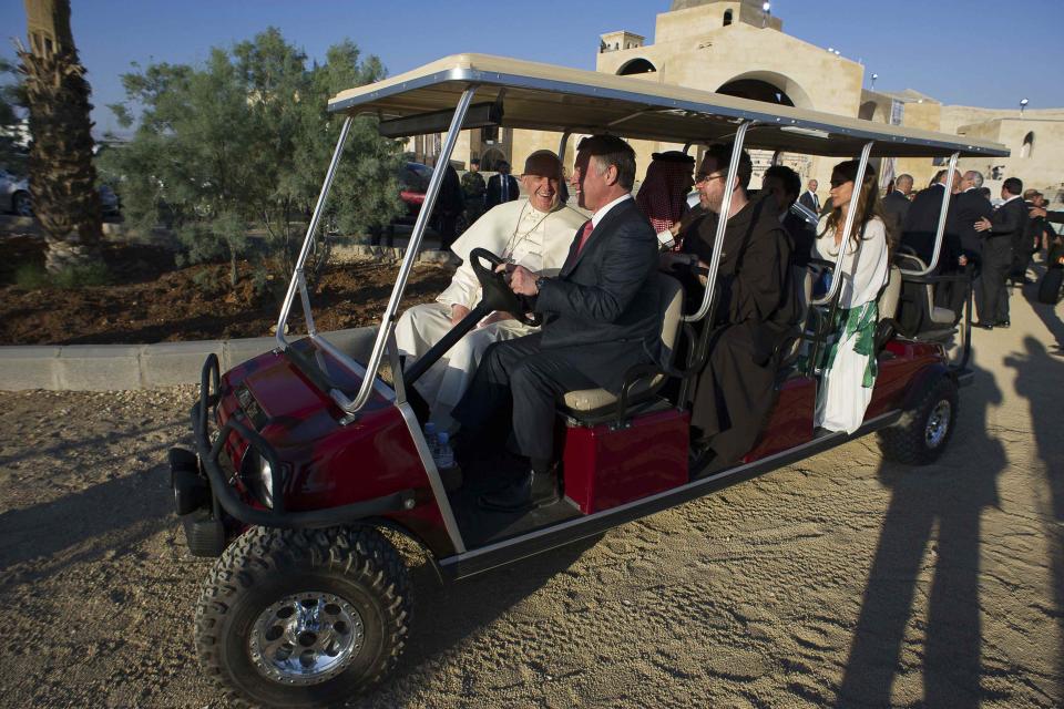 Pope Francis, King Abdullah, and Queen Rania travel in a golf cart during their visit to the site at Jordan River where Jesus is believed to have been baptized