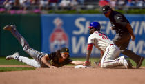 Philadelphia Phillies' Odubel Herrera (37) slides safely into second base for a double past the tag of Pittsburgh Pirates' Cole Tucker, left, during the fifth inning of a baseball game, Sunday, Sept. 26, 2021, in Philadelphia. (AP Photo/Derik Hamilton)