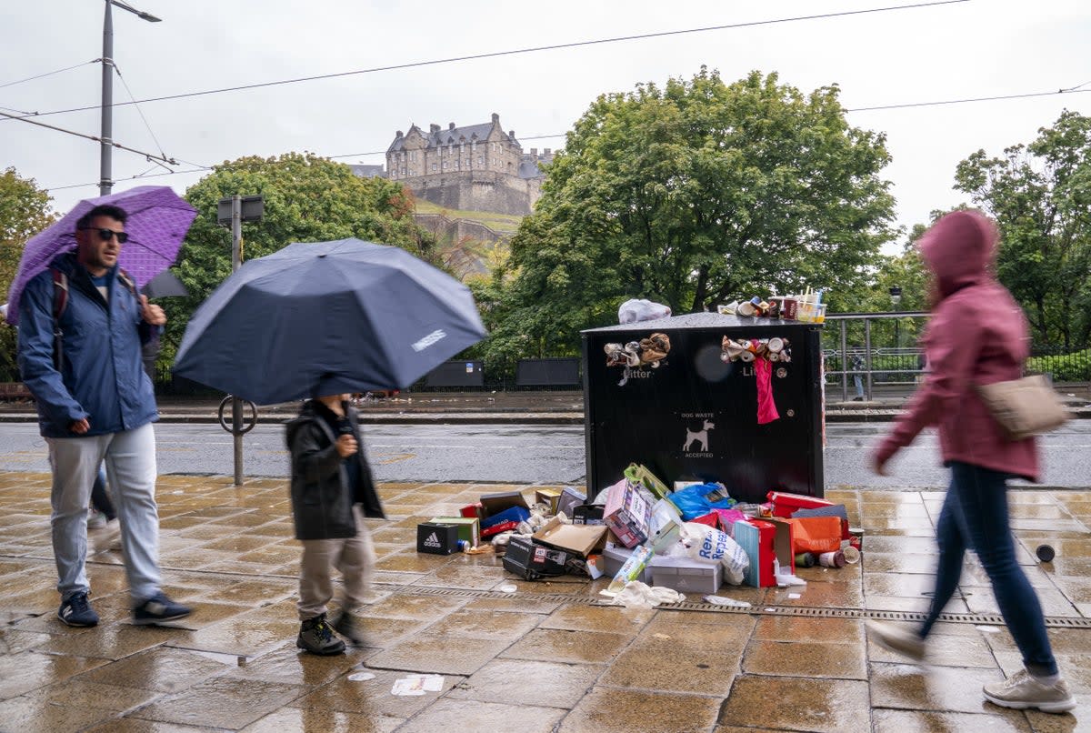 Bins along Princes Street in Edinburgh are overflowing with rubbish while cleansing workers take strike action (Jane Barlow/PA) (PA Wire)