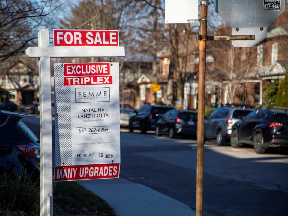 A file photo shows a sign advertising a triplex unit being offered for sale in Toronto, back in December 2021. In May 2023, Toronto council voted to allow to allow construction of multiplexes — including triplexes — across city neighbourhoods. (Carlos Osorio/Reuters - image credit)