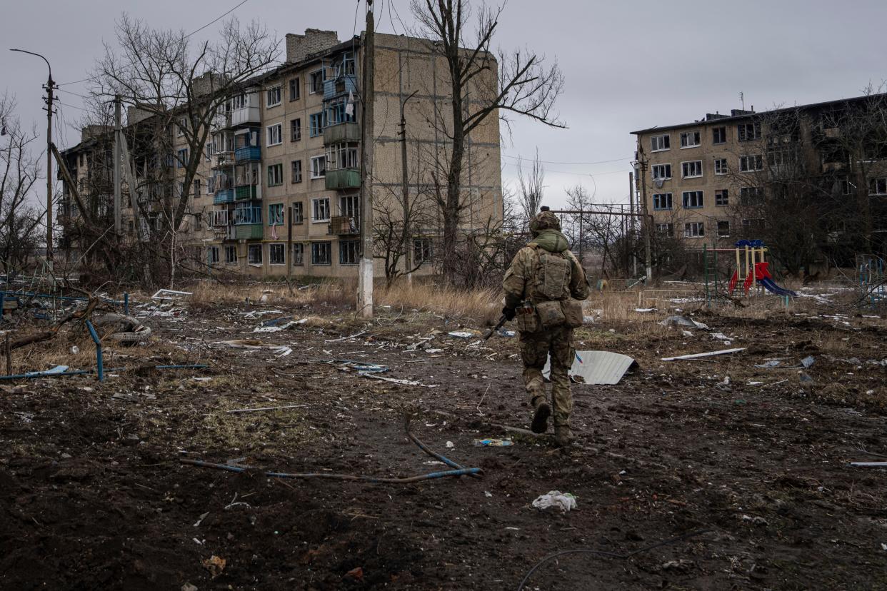 A Ukrainian marine serviceman runs to take a position through the residential blocks in the frontline city of Vuhledar, Ukraine (AP)