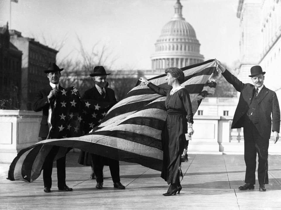 <span>Congresswoman Jeannette Rankin, center, is presented with the flag that flew at the House of Representatives during the passage of the suffrage amendment. (Photo: Bettmann/Getty Images)</span>