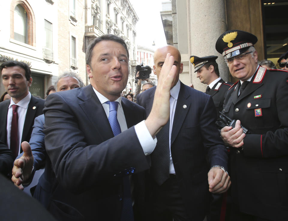 Italian Prime Minister Matteo Renzi waves during his visit in Milan, Italy, Tuesday, May 13, 2014. Renzi later visited the Expo 2015 construction site, where more than 132 countries will be establishing their pavilions for the world's fair that will open on May 1, 2015 and continue until the end of October of that year. (AP Photo/Antonio Calanni)