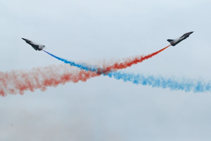China's People's Liberation Army Air Force (PLAAF) Ba Yi aerobatics team perform an aerial display during a media preview of the Singapore Airshow in Singapore