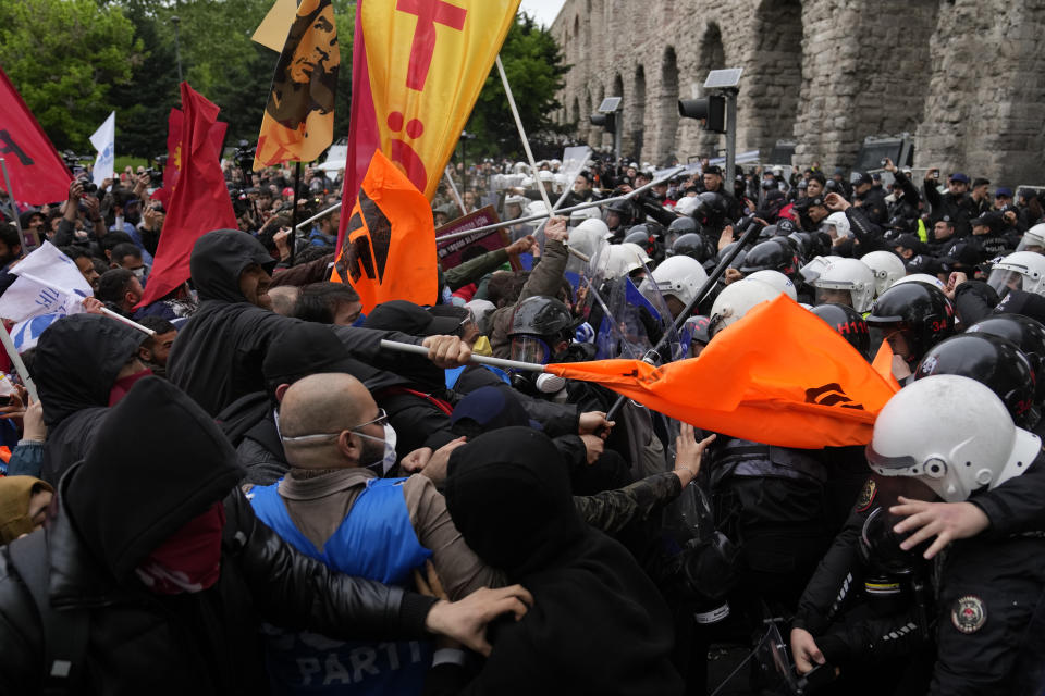 Union members clash with Turkish anti riot police officers as they march during Labor Day celebrations in Istanbul, Turkey, Wednesday, May 1, 2024. Police in Istanbul used tear gas and fired rubber bullets to disperse thousands of people attempting to break through a barricade and reach the city's main city's main square, Taksim, in defiance of a government ban on celebrating May 1 Labor Day at the landmark location. (AP Photo/Khalil Hamra)