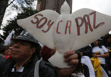 A demonstrator holds a sign reading "I'm peace" during a march in Bogota November 19, 2014. REUTERS/John Vizcaino