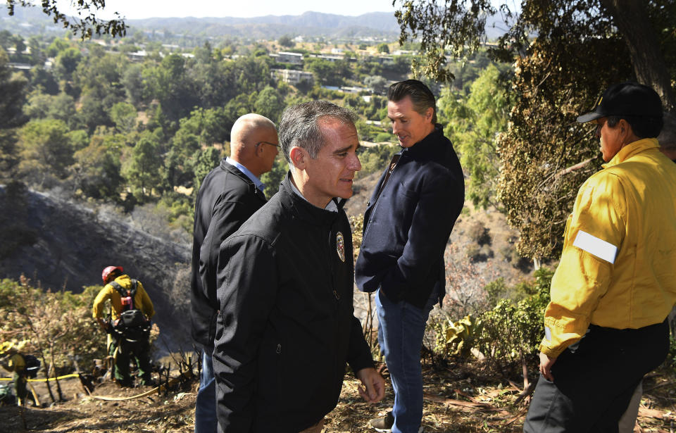 From left, L.A. City Councilman Mike Bonin, California L.A. City Mayor Eric Garcetti and California Governor Gavin Newsom tour Tigertail Road in Brentwood, Calif., Tuesday Oct. 29, 2019. (Wally Skalij/Los Angeles Times via AP, Pool)